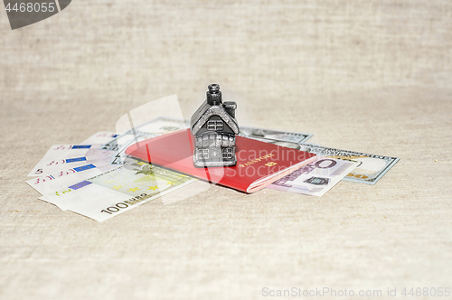 Image of Passport, money and home - the concept of buying a property