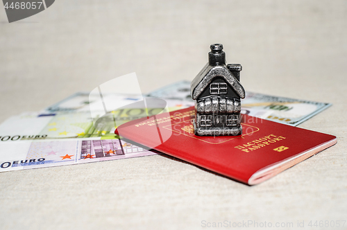 Image of Passport, money and home - the concept of buying a property