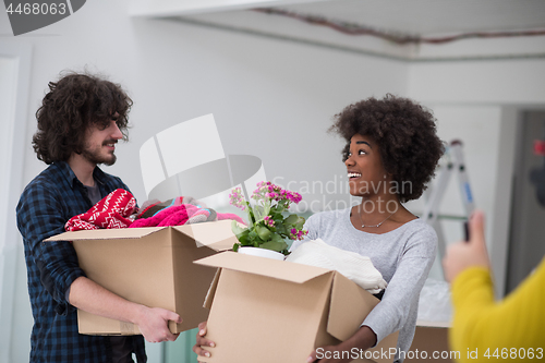 Image of multiethnic couple moving into a new home