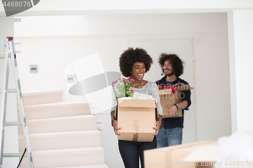 Image of multiethnic couple moving into a new home