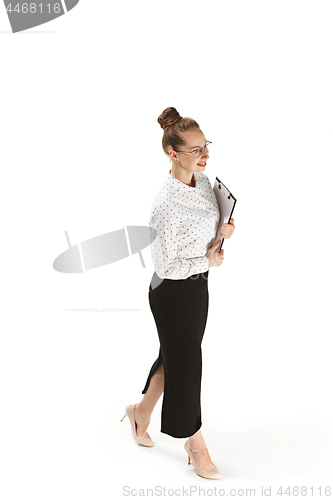 Image of Full length portrait of a smiling female teacher holding a folder isolated against white background