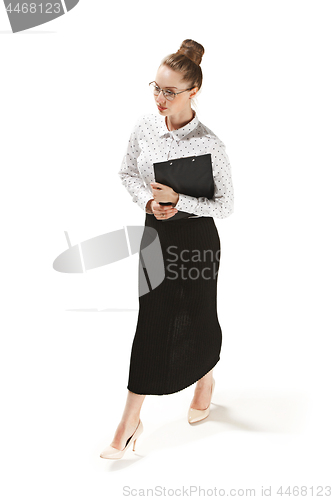 Image of Full length portrait of a smiling female teacher holding a folder isolated against white background