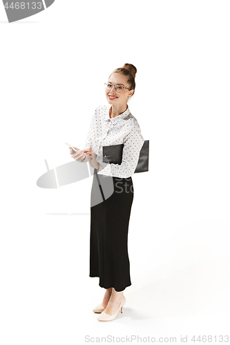 Image of Full length portrait of a smiling female teacher holding a folder isolated against white background