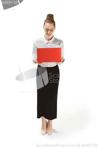 Image of Full length portrait of a smiling female teacher holding a laptop isolated against white background
