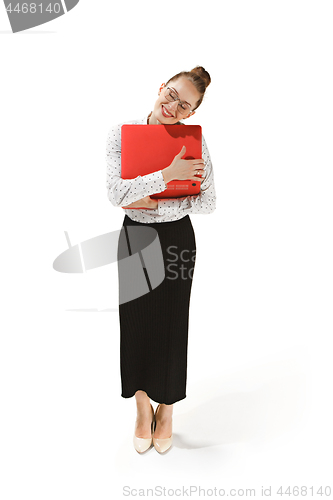 Image of Full length portrait of a smiling female teacher holding a laptop isolated against white background