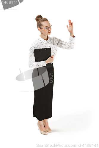 Image of Full length portrait of a female teacher holding a folder isolated against white background