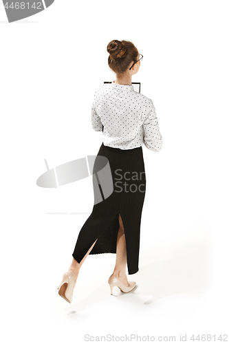 Image of Full length portrait of a back of female teacher holding a folder isolated against white background