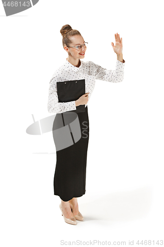 Image of Full length portrait of a female teacher holding a folder isolated against white background