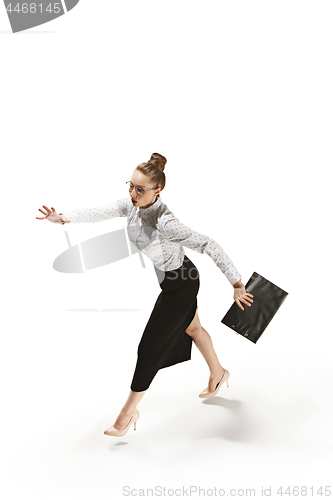 Image of Full length portrait of a smiling female teacher holding a folder isolated against white background