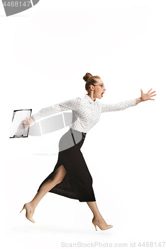 Image of Full length portrait of a smiling female teacher holding a folder isolated against white background