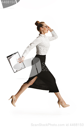 Image of Full length portrait of a smiling female teacher holding a folder isolated against white background