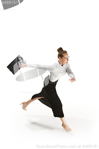 Image of Full length portrait of a smiling female teacher holding a folder isolated against white background