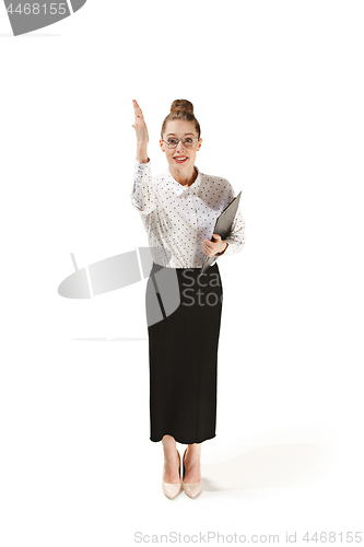 Image of Full length portrait of a female teacher holding a folder isolated against white background