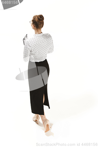 Image of Full length portrait of a back of female teacher holding a folder isolated against white background