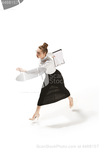 Image of Full length portrait of a smiling female teacher holding a folder isolated against white background