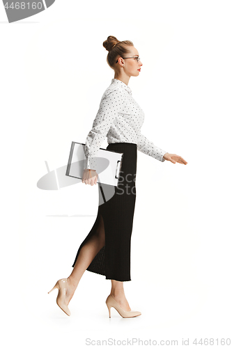 Image of Full length portrait of female teacher holding a folder isolated against white background