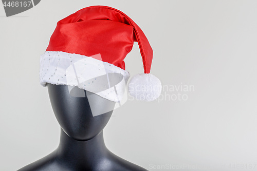 Image of A head of female mannequin with santa claus hat isolated on white background.