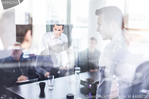 Image of Business team brainstorming on meeting in modern corporate office.