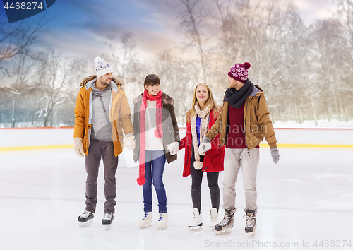 Image of happy friends on outdoor skating rink
