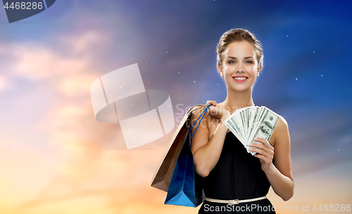 Image of smiling woman in dress with shopping bags