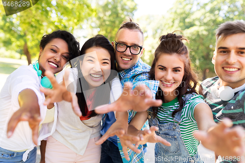 Image of happy smiling friends having fun in park