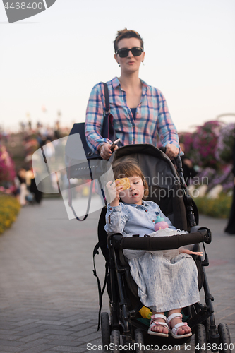 Image of mother and daughter in flower garden