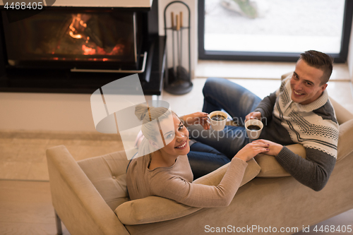 Image of Young couple  in front of fireplace