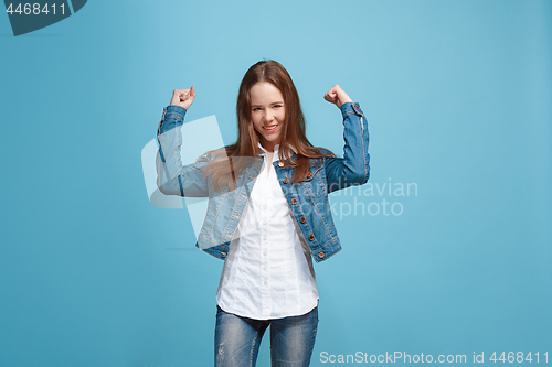 Image of Happy success teen girl celebrating being a winner. Dynamic energetic image of female model