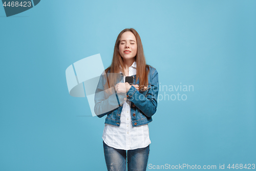 Image of Beautiful teen girl looking suprised isolated on blue