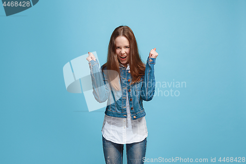 Image of Happy success teen girl celebrating being a winner. Dynamic energetic image of female model