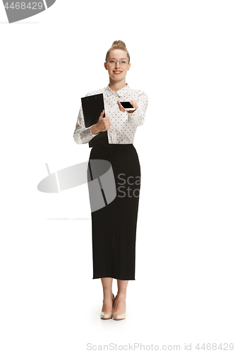 Image of Full length portrait of a smiling female teacher holding a folder isolated against white background