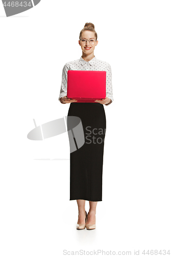 Image of Full length portrait of a smiling female teacher holding a laptop isolated against white background