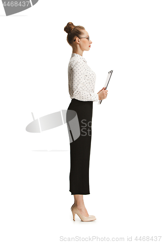 Image of Full length portrait of a female teacher holding a folder isolated against white background