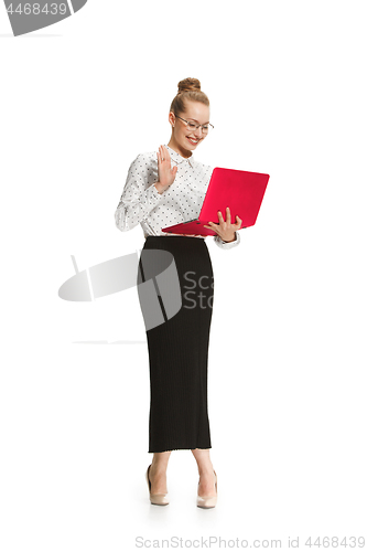 Image of Full length portrait of a smiling female teacher holding a laptop isolated against white background