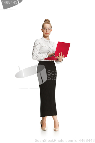 Image of Full length portrait of a smiling female teacher holding a laptop isolated against white background