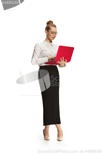 Image of Full length portrait of a smiling female teacher holding a laptop isolated against white background