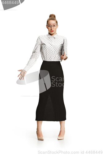 Image of Full length portrait of a surprised female teacher holding a folder isolated against white background