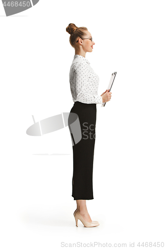 Image of Full length portrait of a female teacher holding a folder isolated against white background