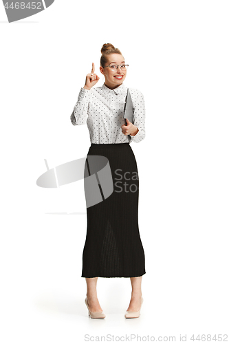 Image of Full length portrait of a smiling female teacher holding a folder isolated against white background