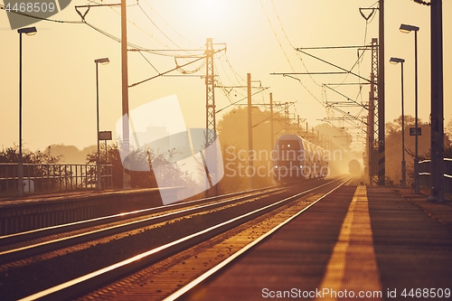 Image of Passenger train at sunrise.