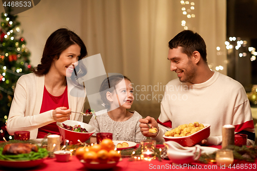 Image of happy family having christmas dinner at home