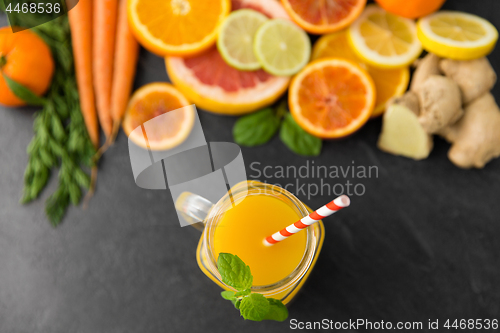 Image of mason jar glass of fruit juice on slate table top