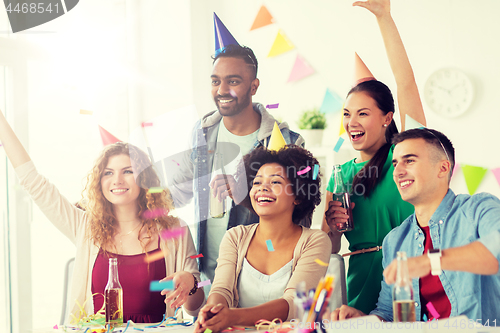 Image of happy team with confetti at office birthday party