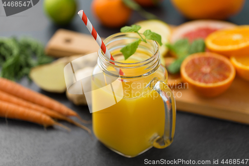 Image of mason jar glass of fruit juice on slate table top