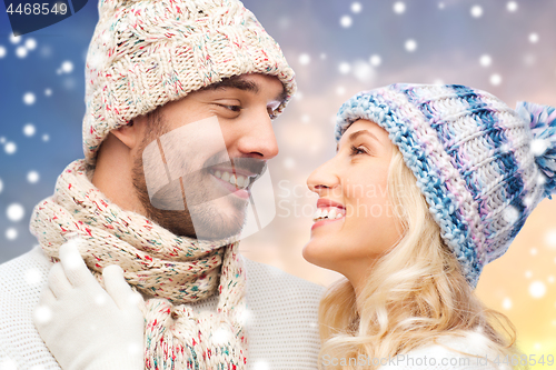 Image of close up of couple in winter clothes over snow