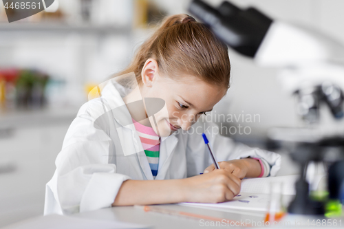 Image of girl studying chemistry at school laboratory