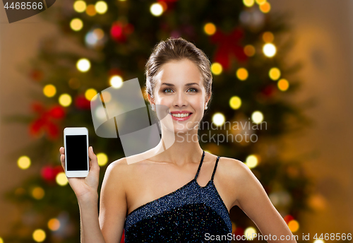 Image of woman with smartphone on christmas