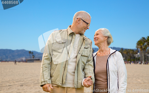 Image of happy senior couple over venice beach background