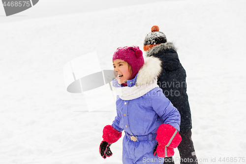 Image of happy little kids playing outdoors in winter