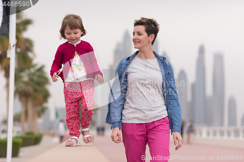 Image of mother and cute little girl on the promenade